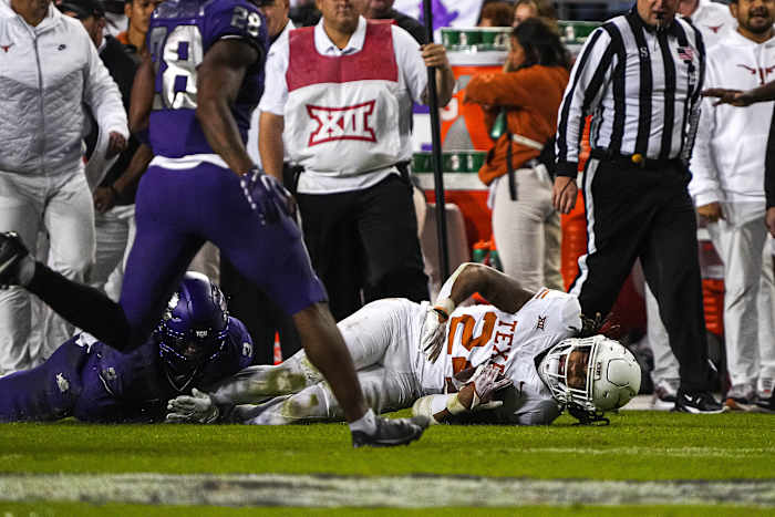 Texas Longhorns running back Jonathon Brooks (24) is brought down by TCU cornerback Josh Newton (3) during the game at Amon G. Carter Stadium on Saturday, Nov. 11, 2023 in Fort Worth, Texas
